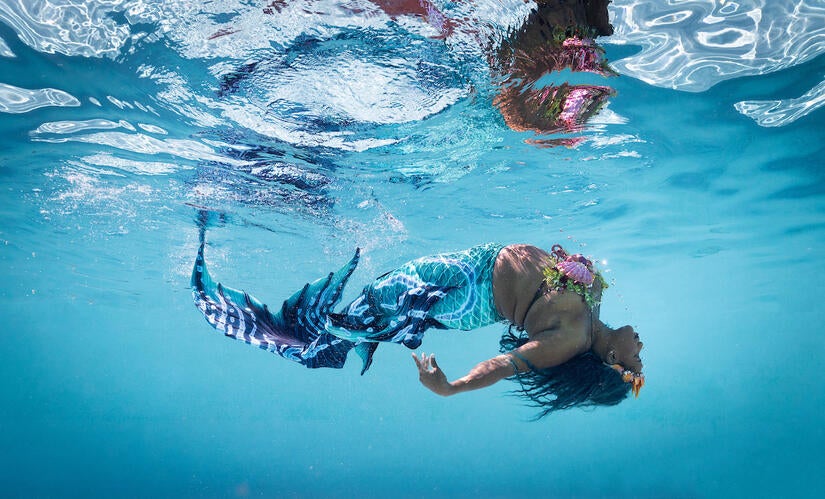 Mermaid Tiva poses on March 7, 2023. Mermaid Tiva is the swim coach for Jalondra Davis, assistant professor of English, who is a scholar in Africana/Black literary and cultural studies, women and gender studies, and contemporary genre fictions and popular culture, which includes Black mermaids in literature and film. (Photo Illustration by UCR/Stan Lim)